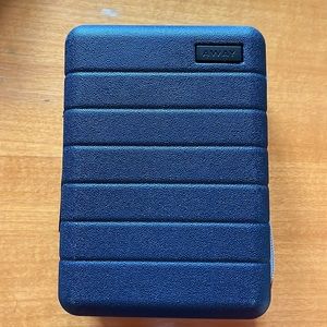 Away Mini travel case, filled with goodies for an overnight trip.